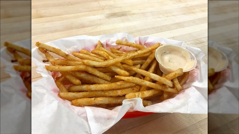Fries next to sauce in basket at Westside Drive-In