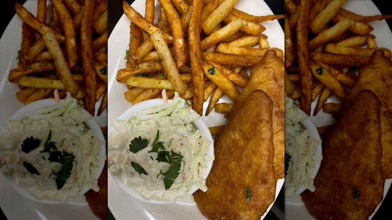 Top-down shot of plate with fries, coleslaw, and fried fish fillets