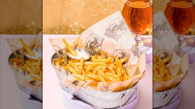 Tin bucket holding french fries in front of beer at Hopcat