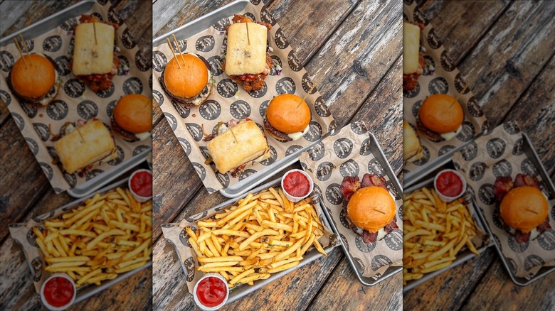 Top-down shot of sliders and fries on wooden table