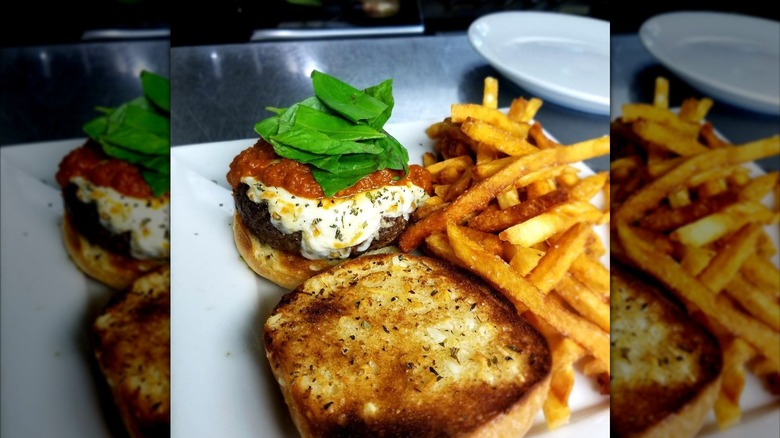 Open-faced burger and fries on counter