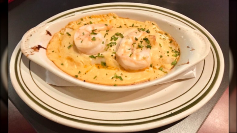 Seafood manicotti with shrimp on white plates