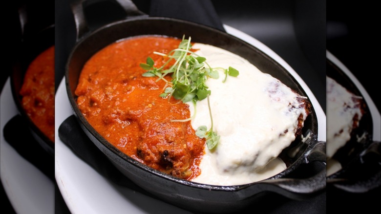Sauce-covered lasagna in a cast iron pan