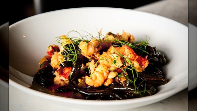 White bowl with squid ink pasta