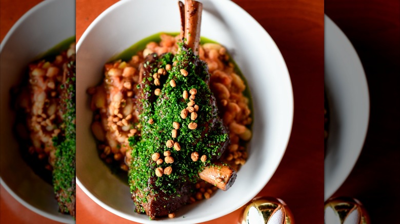 Red wine braised lamb shank in white bowl