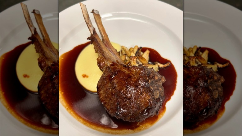 Lamb chpos with sauce on white plate