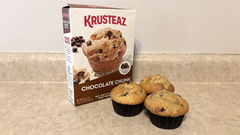 A box of Krusteaz chocolate chunk muffin mix with three muffins