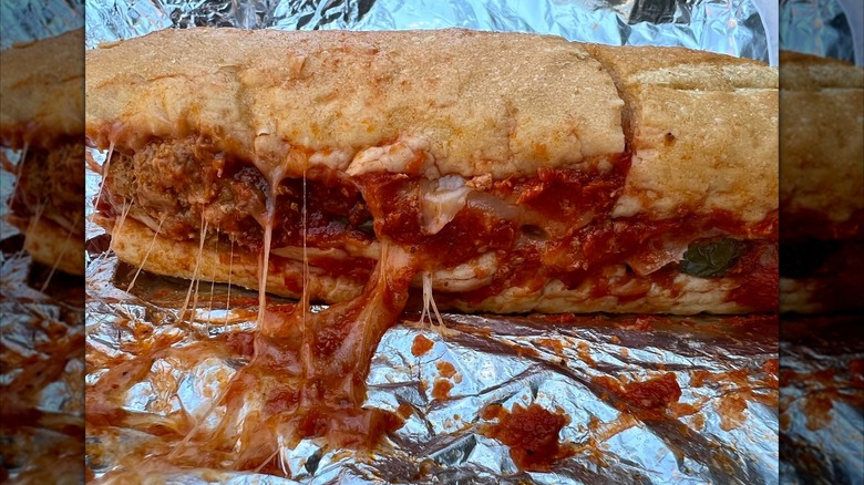 Meatball sub with melty cheese on foil wrap