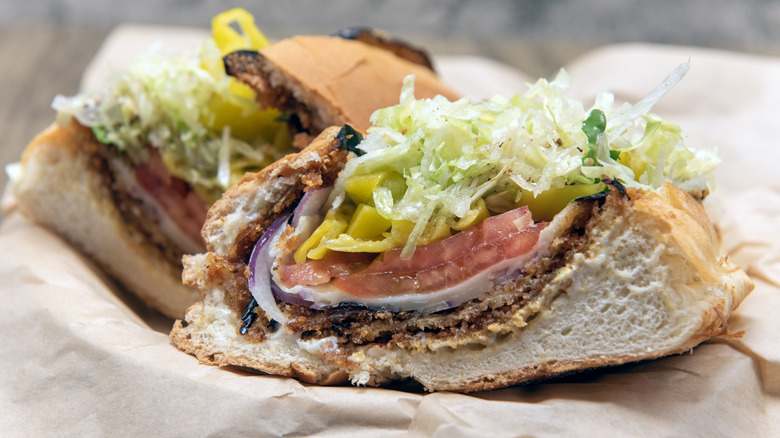 Loaded vegan sandwich displayed on brown paper