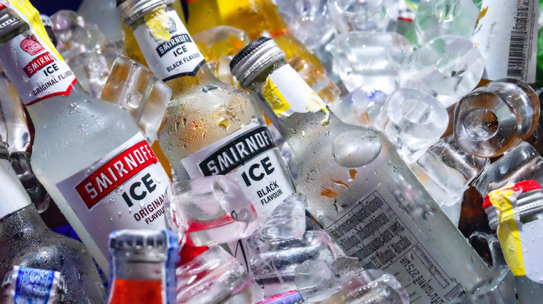 various bottles of Smirnoff Ice flavors nestled in ice cubes