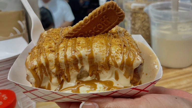 Biscoff cinnamon roll in container at fair stand