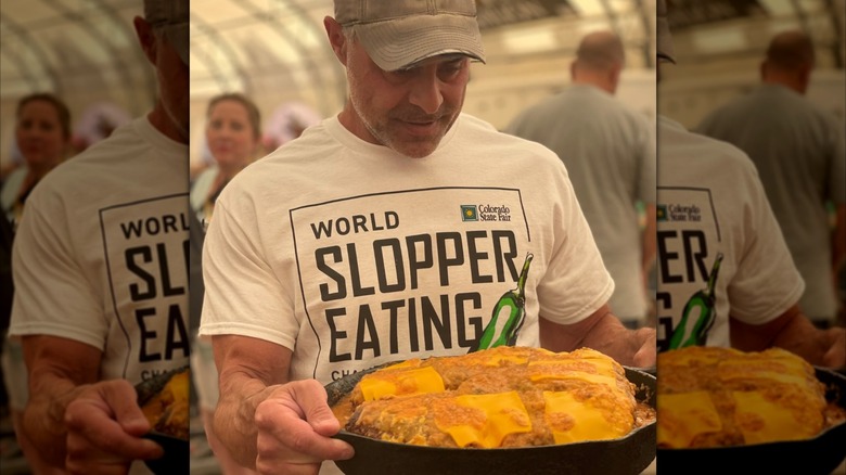 Plate with many sloppers held by person wearing a t-shirt from the World Slopper Eating contest