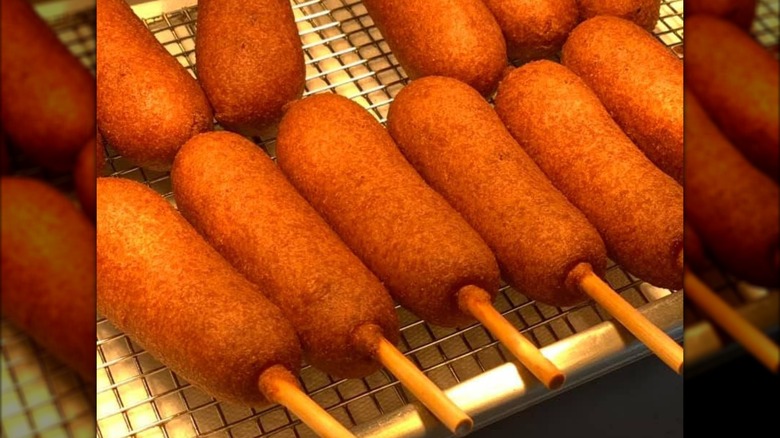 Corn dogs draining on wire rack