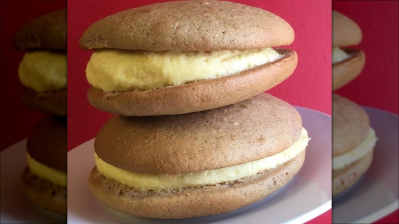 Two eggnog-flavored whoopie pies on plate