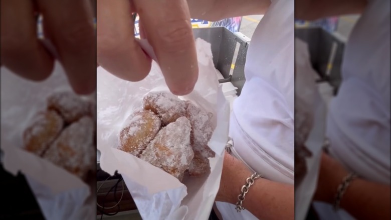 Looking into an open bag of sugar-covered zeppoles
