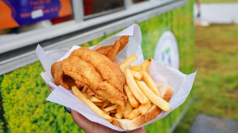 Fried catfish, fries, and bread in tray
