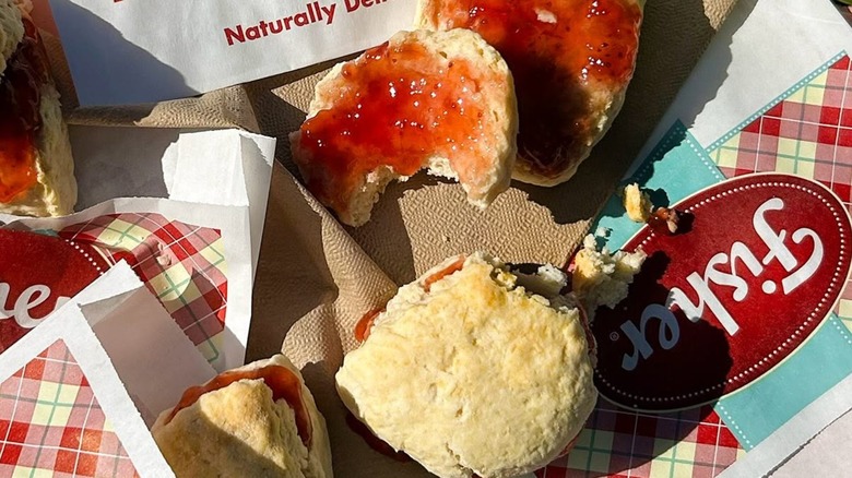 Several scones with raspberry jam on Fisher branded papers