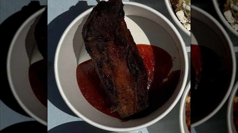 Rib in cup with BBQ sauce