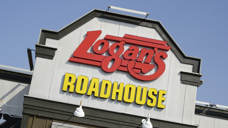 Yellow and red logo sign outside of Logan's Roadhouse restaurant