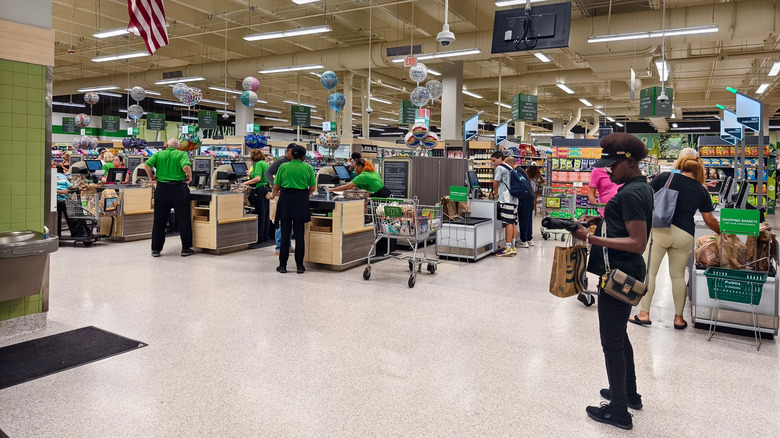 Registers, employees, and customers inside a Publix location