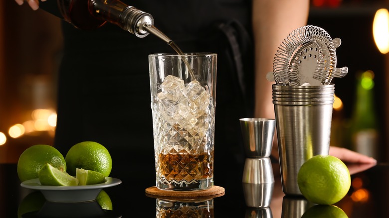 bartender pouring liquor in glass