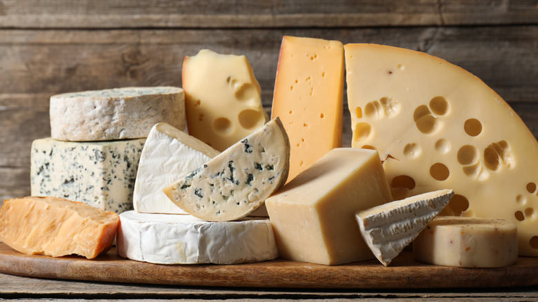 Cheese varieties on wooden table