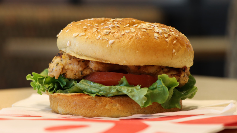 Chick-fil-A grilled chicken sandwich with lettuce and tomato sitting on table