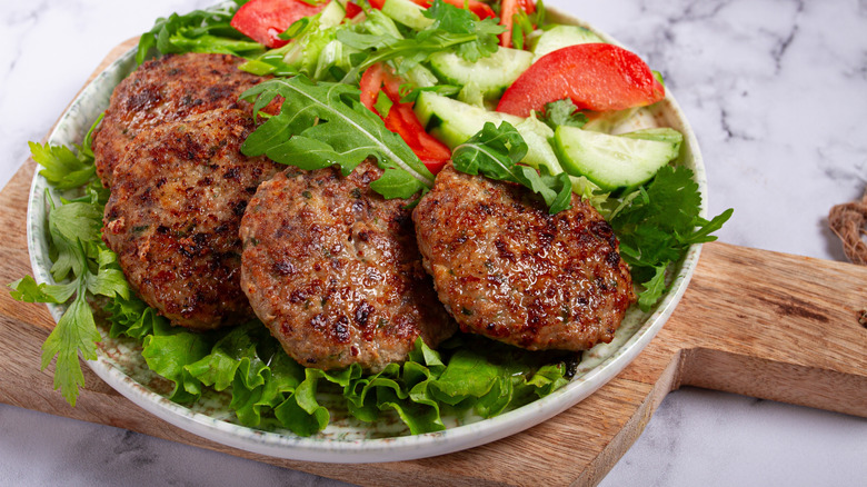 Arugula salad topped with hearty homemade meatballs