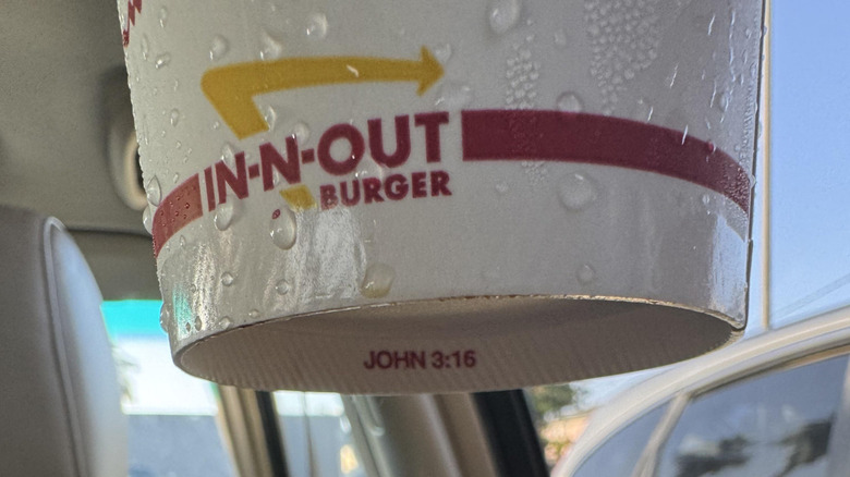 The bottom of an In-N-Out soda cup with John 3:16 printed on the rim