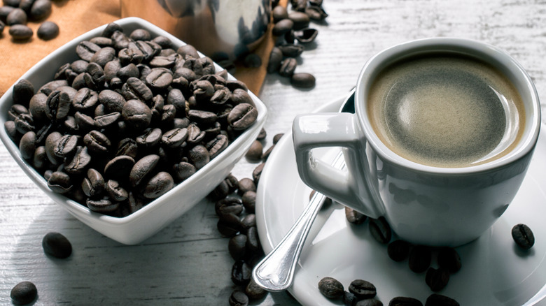 Mug of coffee with coffee beans