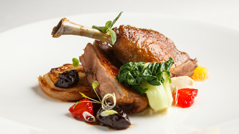 duck confit on white plate