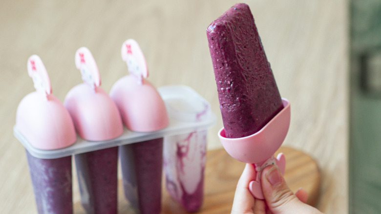 purple popsicle in silcone mold with the rest of the mold in the background