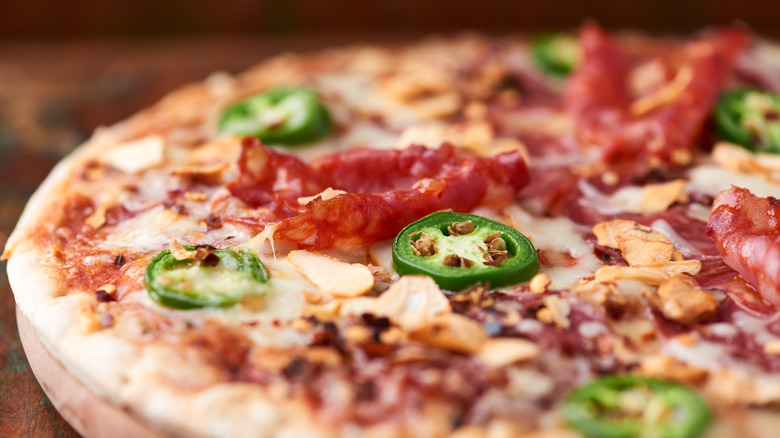 spicy pizza with jalapenos, chile flakes, and ham
