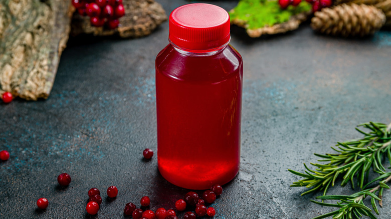 Lingonberries and juice in a plastic bottle