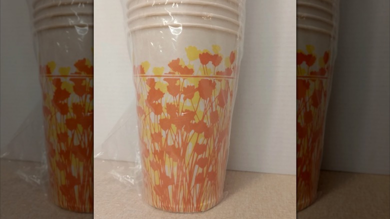 Stack of orange and yellow flowers cups wrapped in plastic