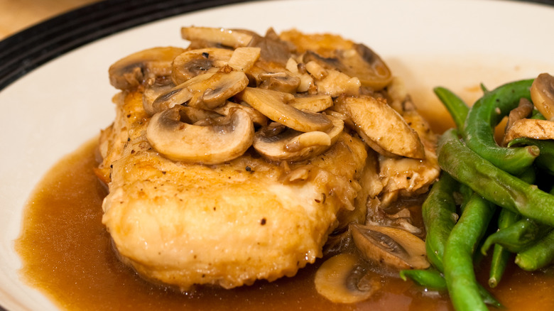 Plate of chicken with marsala sauce, mushrooms, and green beans
