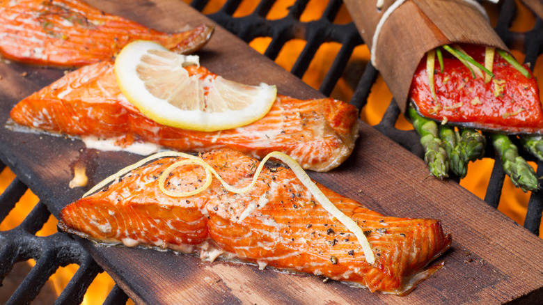 Salmon grilling on wood plank