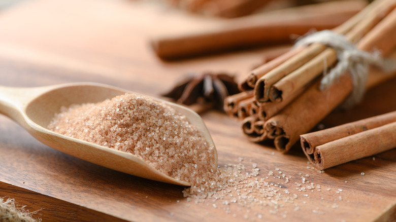 Cinnamon sugar in scoop with sticks
