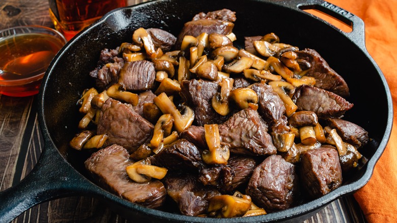 Steak tips and mushrooms in pan