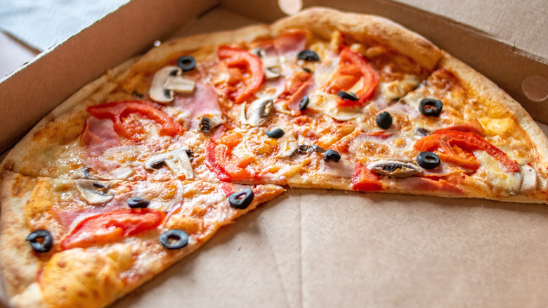 Leftover pizza in a cardboard pizza box