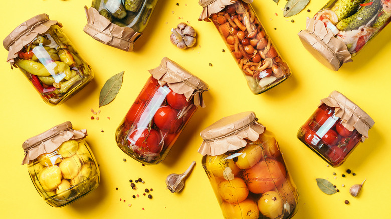 different types of canned food on a yellow background