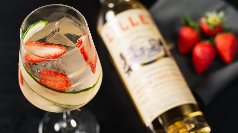 A Lillet aperitif cocktail, bottle of Lillet, and strawberries