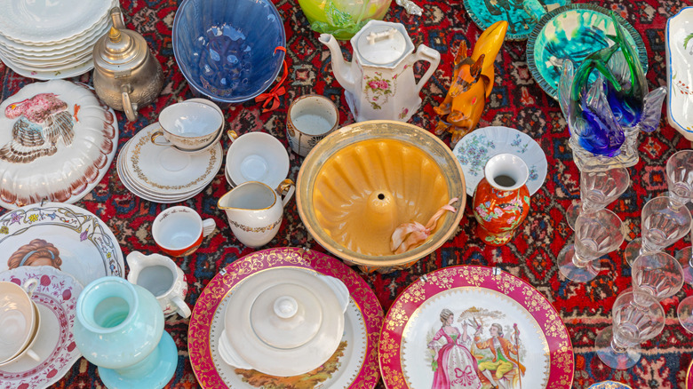 Selection of vintage dishware on a red, patterned rug