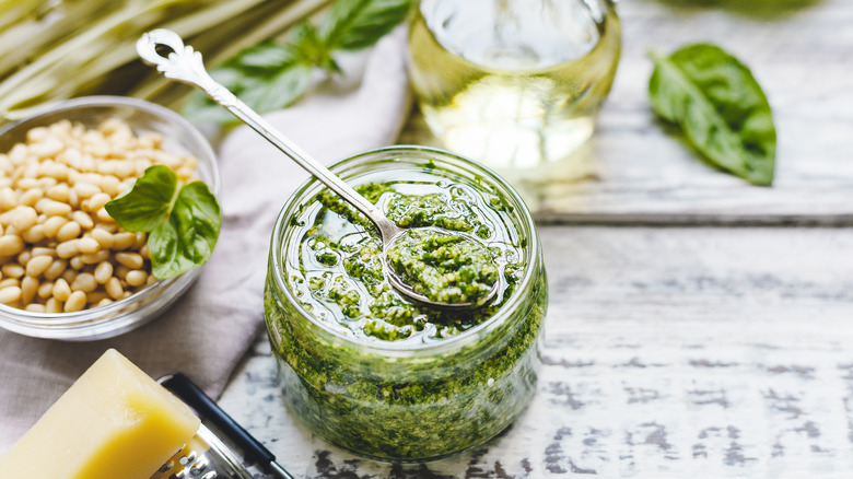 homemade pesto with basil, cheese and oil around it
