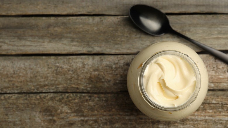 Jar of mayo with a black spoon.