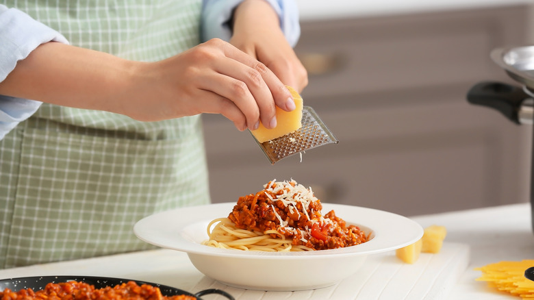 cheese grated over pasta Bolognese