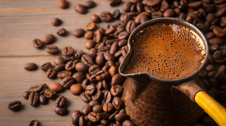 Closeup of Turkish coffee pot and coffee beans on a table
