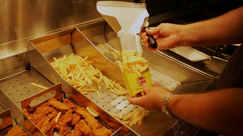 Worker boxing fries at the Wendy's fry station