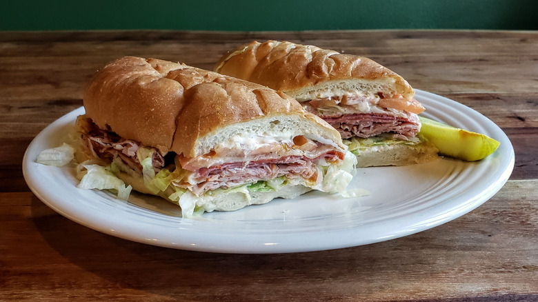 Sliced submarine sandwich served on plate.