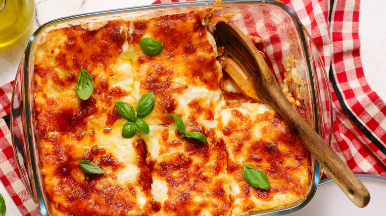A homemade cooked lasagna with basil leaves